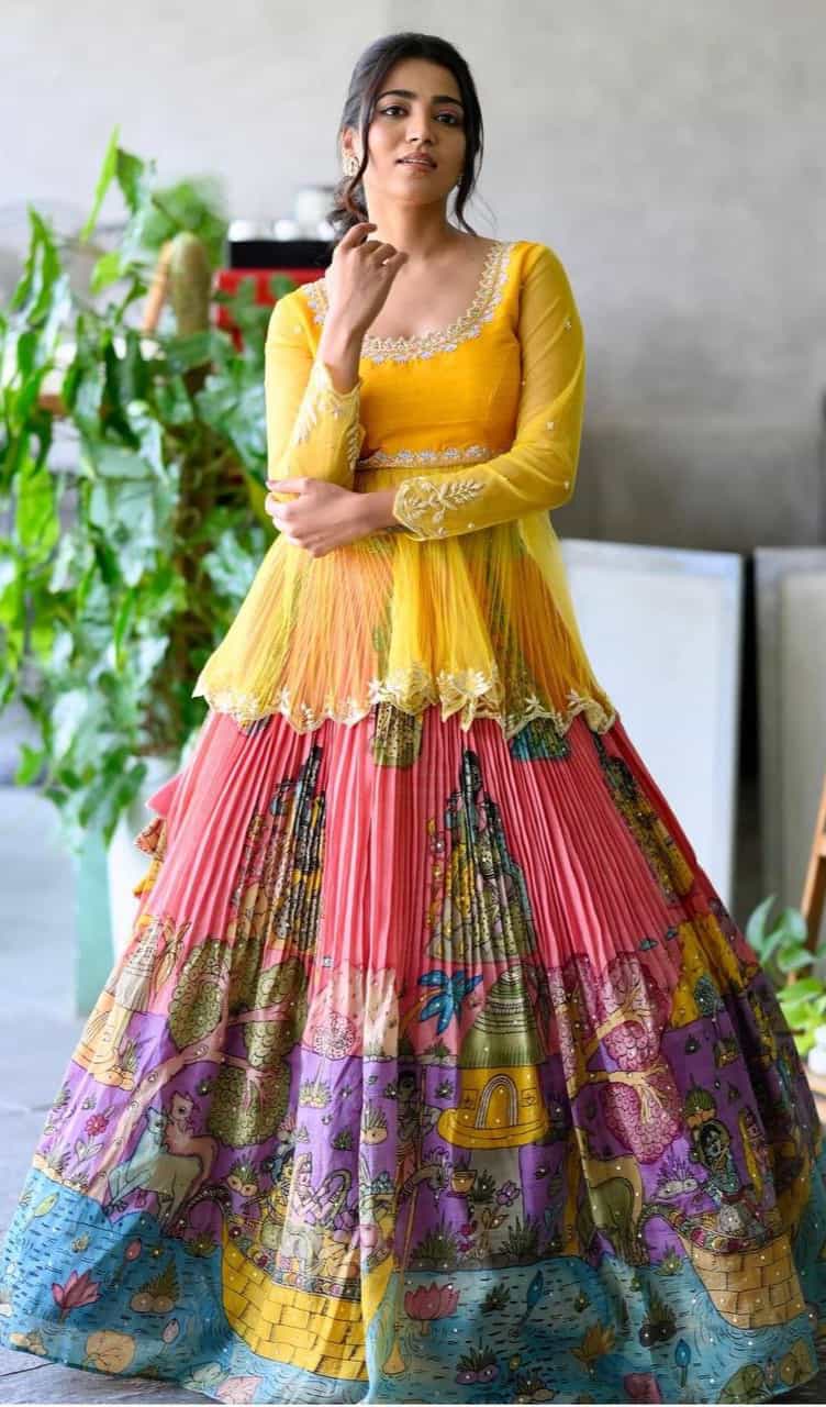 lehenga crafted from tabby organza silk with digital print, complemented by a silk inner and embroidered faux georgette kurti