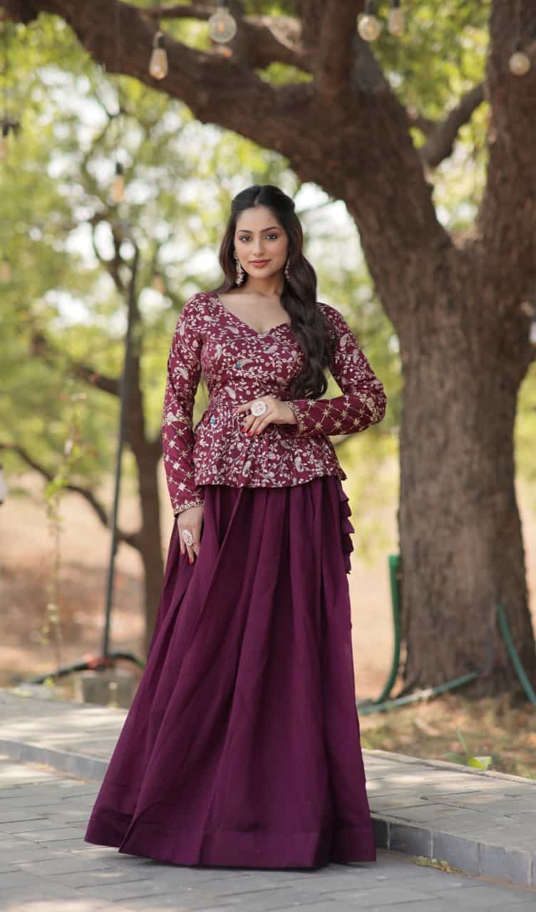 wine lehenga crafted from shimmer Vichitra fabric, paired with a full-sleeved embroidered viscose jacquard peplum blouse