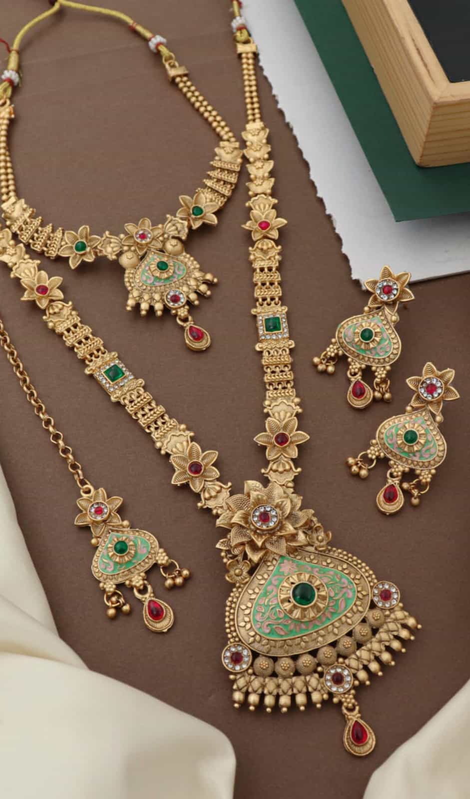 Royal bridal jewelry set featuring layered necklaces and earrings