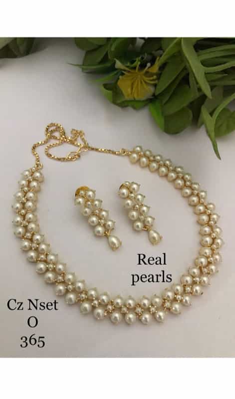 pearl earrings and necklace displayed in a beautiful set, highlighting the timeless allure of these classic gemstones