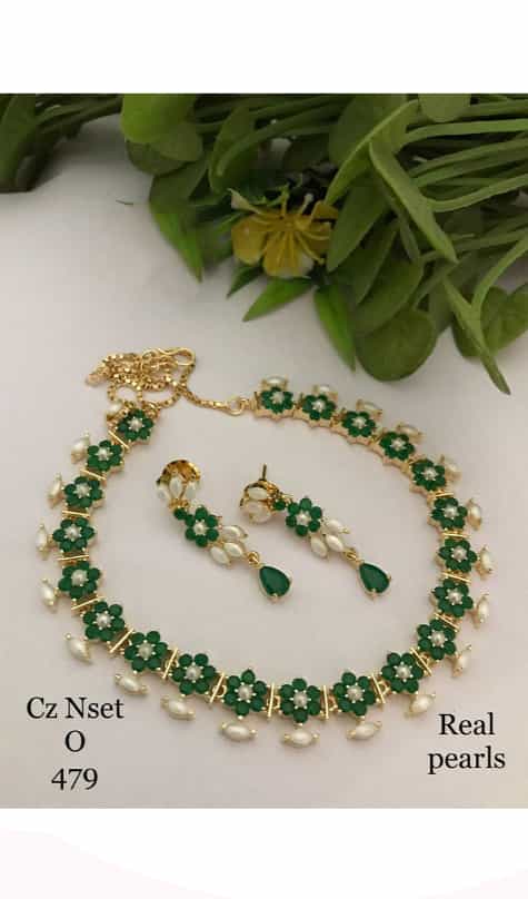 designed green pearl earrings, part of a set, exemplifying the timeless elegance of pearls