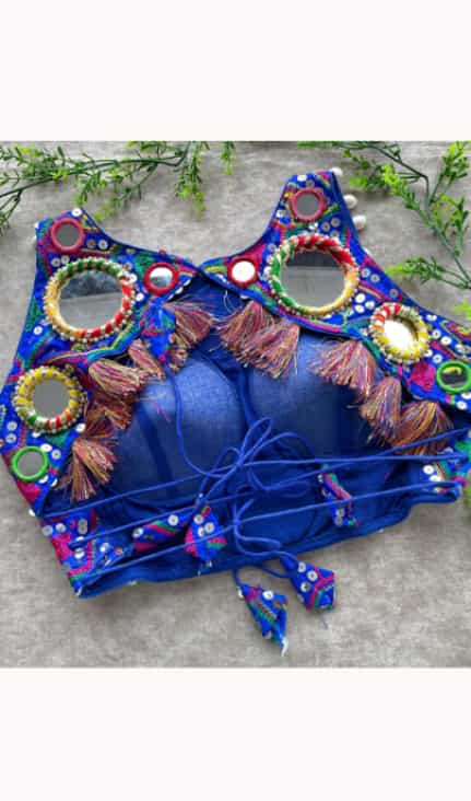 Stylish dark blue blouse featuring intricate kaudi work and festive detailing