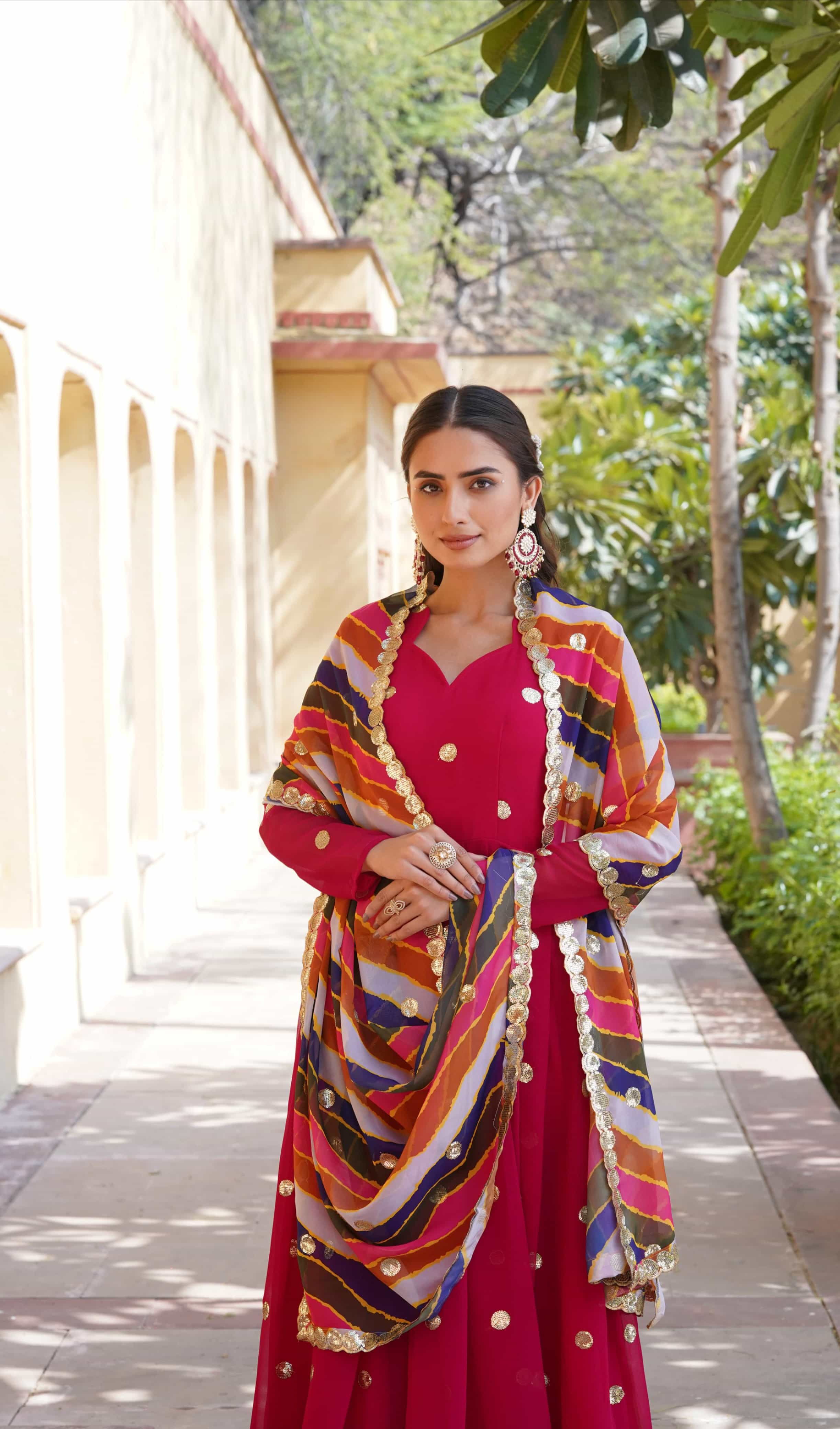 Designer red gown with fancy V-neck and full sleeves