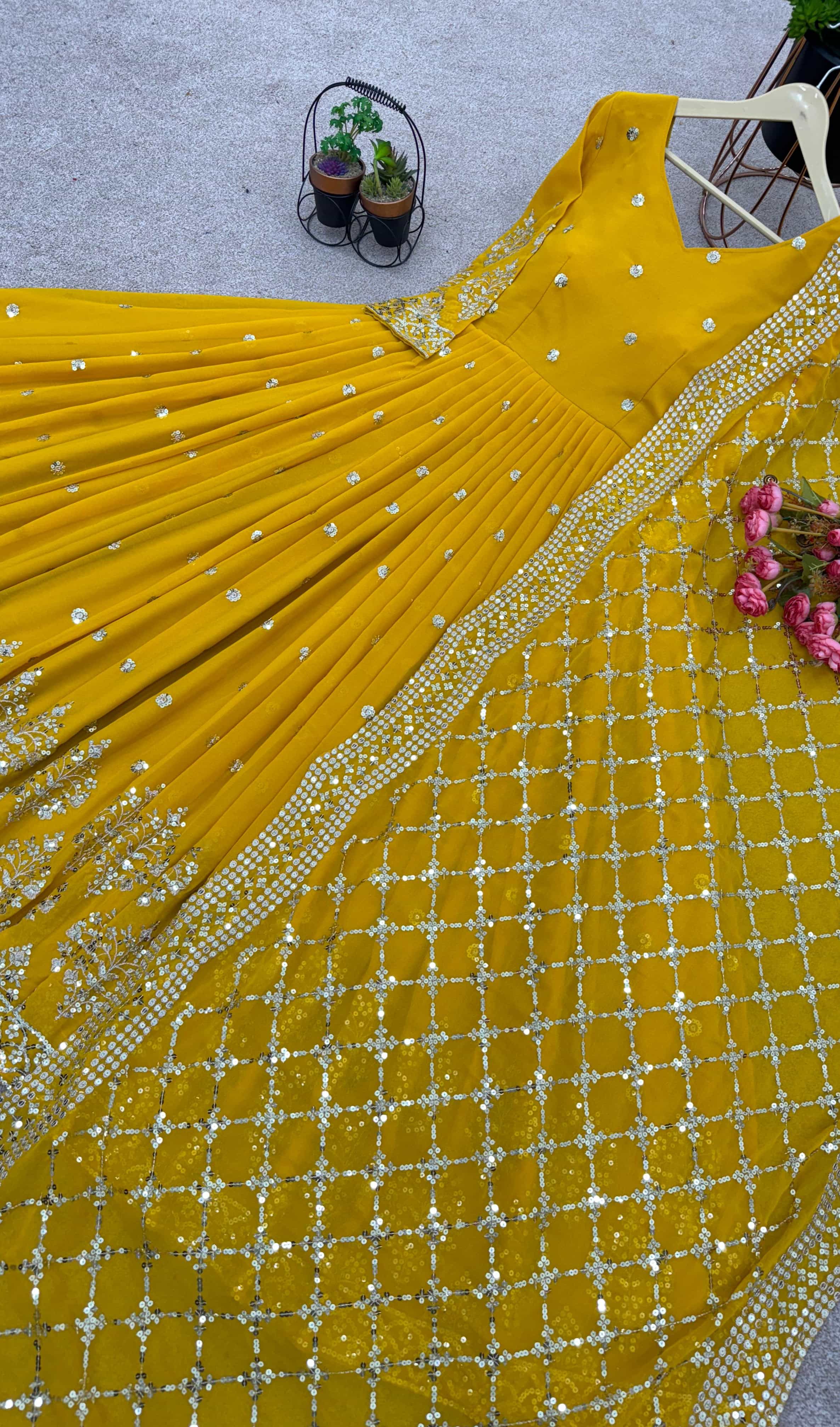  yellow gown with a heavily embroidered faux georgette dupatta