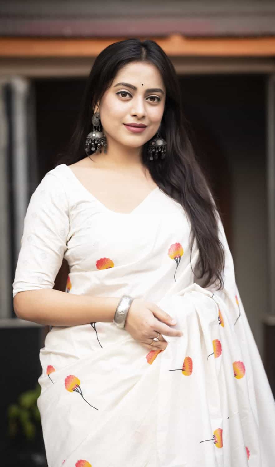 Traditional white saree with intricate silver weaving