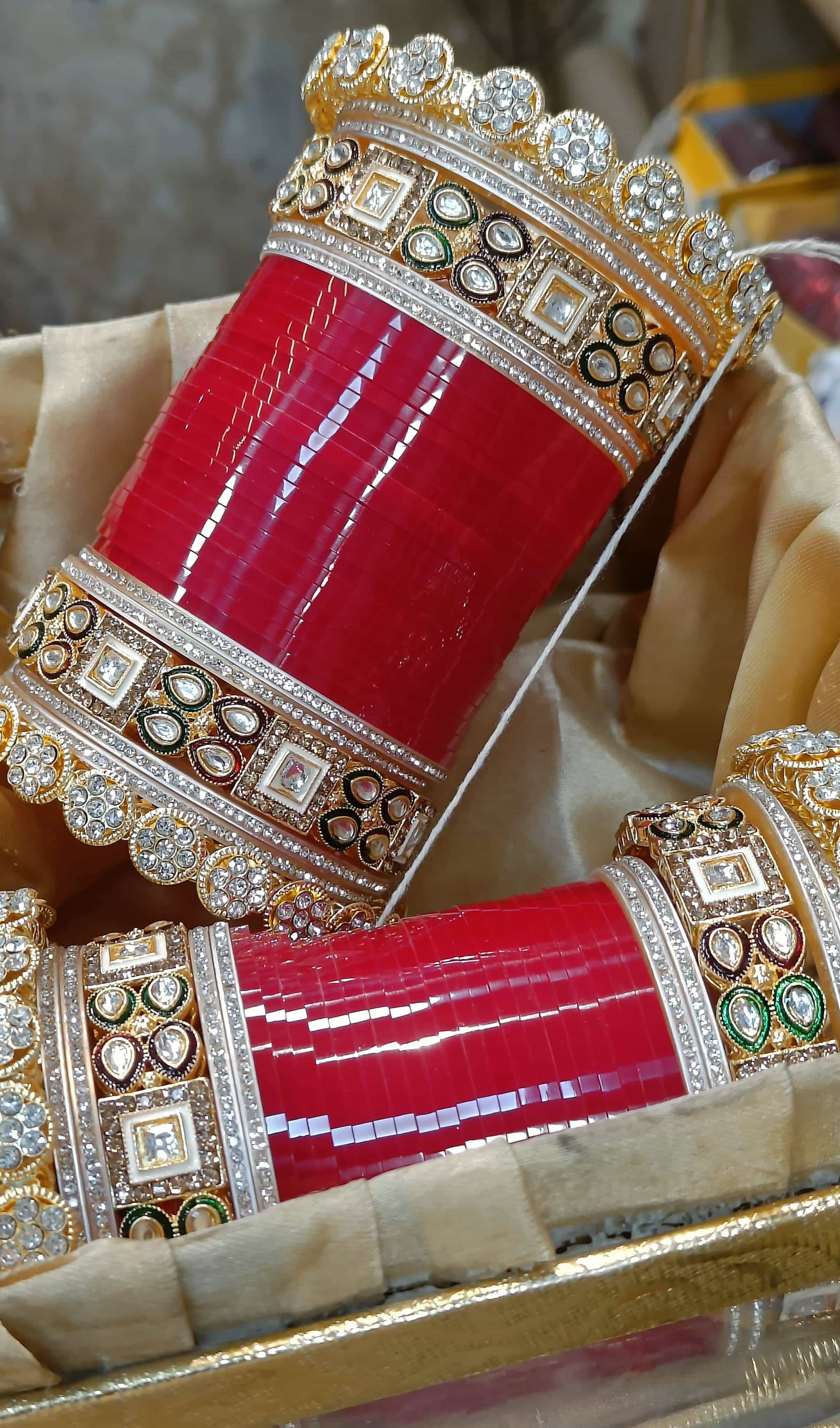 beautifully arranged pair of red and gold bangles