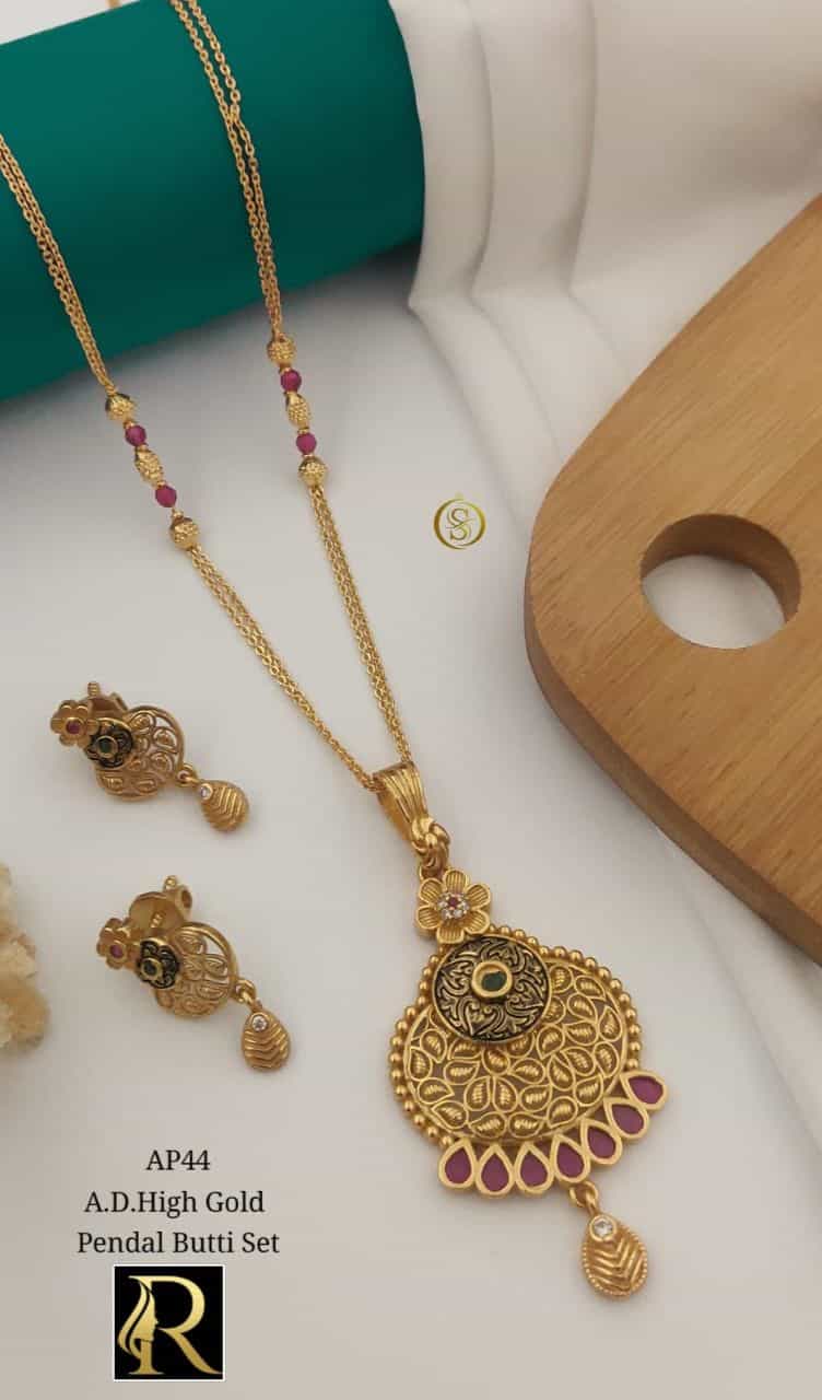 golden necklace and earrings with sparkling stones